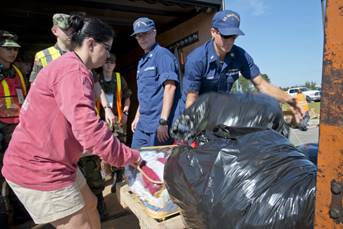 Volunteers from various response agencies unload donated clothing in Lumberton, North Carolina, Oct. 16, 2016. Petty Officer 1st Class James Prosser (center) coordinated donations from members of Coast Guard Sector North Carolina and other community members of Wilmington, North Carolina, and helped deliver items to Lumberton after flood waters damaged homes in the town after Hurricane Matthew. (U.S. Coast Guard photo by Petty Officer 2nd Class Nate Littlejohn)