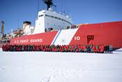 The crew of the Coast Guard Cutter Polar Star poses for a photo on the frozen Ross Sea off of Antarctica, Jan. 11, 2017.  The crew, operating as part of Operation Deep Freeze 2017, was deployed to perform Antarctic icebreaking operations to ensure the delivery of essential supplies to the National Science Foundation's McMurdo Station.  U.S. Coast Guard photo by Chief Petty Officer David Mosley.