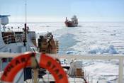 The crew of the motor vessel Ocean Giant lines up with the U.S. Coast Guard Cutter Polar Star as they prepare to be escorted to the National Science Foundation’s McMurdo Station, Jan. 25, 2017.  The Polar Star’s crew conducted a multi-hour escort, creating a safe and navigable path through the frozen Ross Sea to the station. U.S. Coast Guard photo by Chief Petty Officer David Mosley.