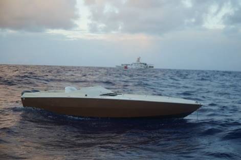 A go-fast interdicted, with three suspected smugglers and 2,606 pounds of cocaine onboard, by the Coast Guard Cutter Joseph Tezanos (in the background) and Caribbean Border Interagency Group partner agencies Dec. 11, 2018, sits adrift, approximately 95 nautical miles northeast of Saint Thomas, U.S. Virgin Islands. The interdiction was the result of Operation Full Court Press, a Department of Homeland Security multi-agency initiative to disrupt Transnational Criminal Organizations within the maritime approaches to the southeastern United States.